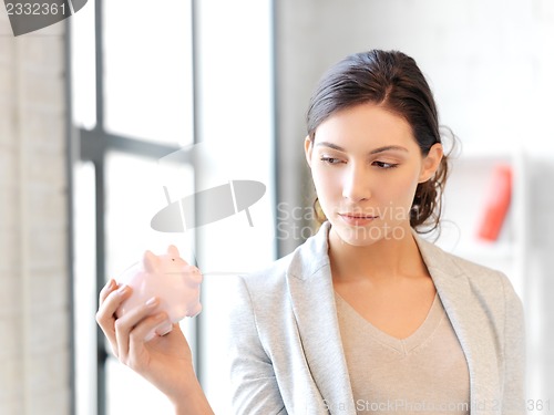 Image of lovely woman with piggy bank