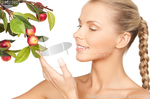 Image of lovely woman with apple twig