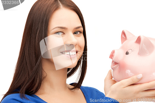 Image of lovely woman with piggy bank