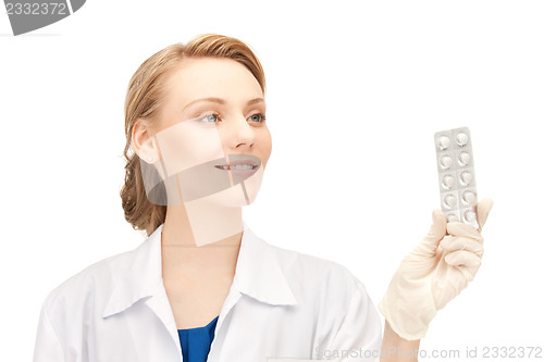 Image of attractive female doctor with pills