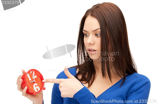 Image of woman holding alarm clock