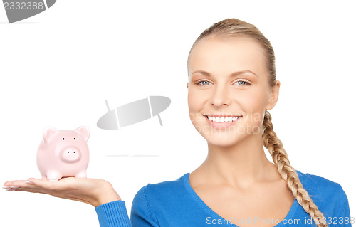 Image of lovely woman with piggy bank