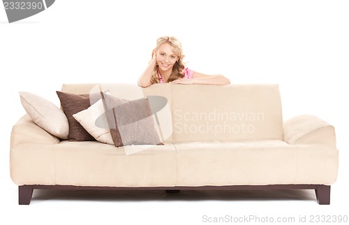 Image of happy woman on sofa