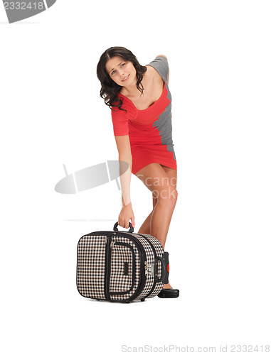 Image of unhappy woman with heavy suitcase