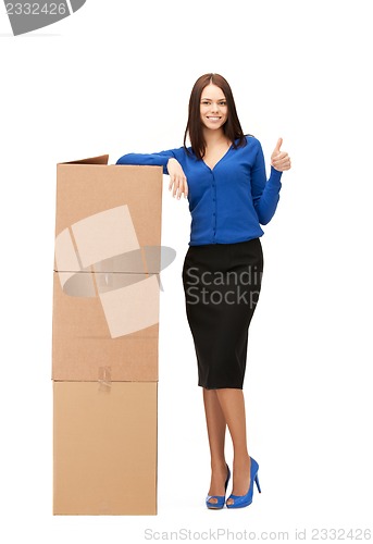 Image of attractive businesswoman with big boxes