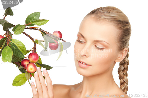Image of lovely woman with apple twig