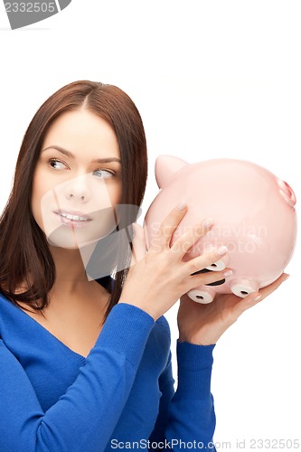 Image of lovely woman with piggy bank