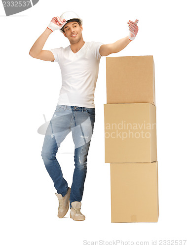 Image of handsome builder with big boxes