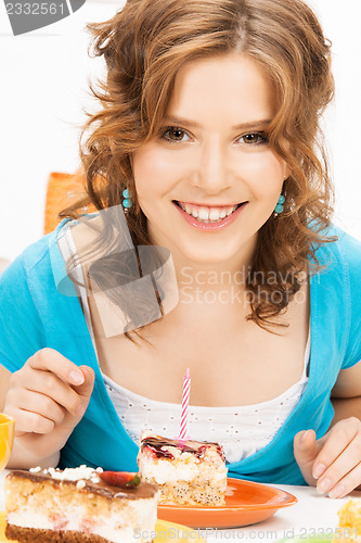 Image of lovely housewife with cake and candle