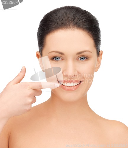 Image of beautiful woman pointing to teeth