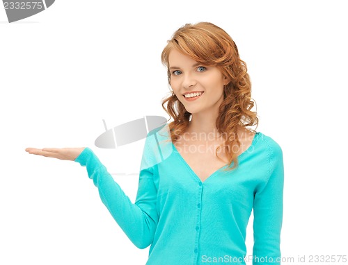 Image of girl showing something on the palm of her hand