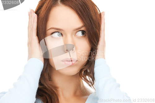 Image of woman with hands on ears