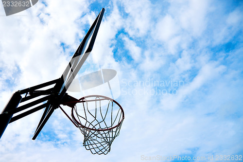 Image of basketball basket over blue sky