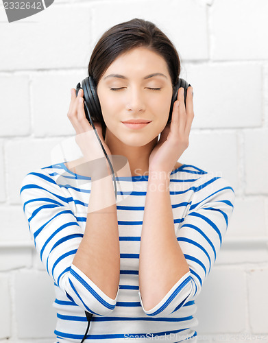 Image of happy teenage girl in big headphones