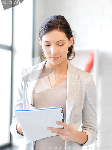 Image of happy woman with big notepad