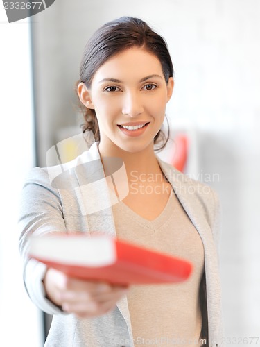 Image of happy and smiling woman with book