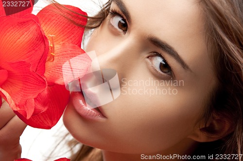 Image of lovely woman with red flowers