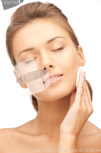 Image of beautiful woman with cotton pad