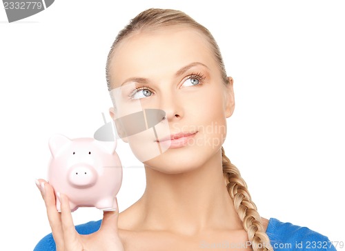 Image of lovely woman with piggy bank