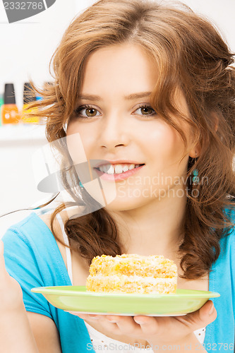 Image of lovely housewife at the kitchen with sweets