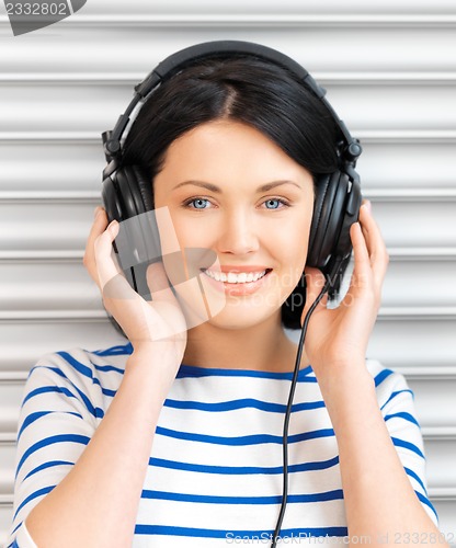 Image of happy teenage girl in big headphones