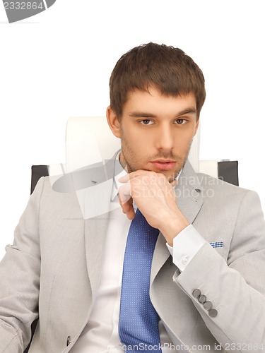 Image of young businessman sitting in chair