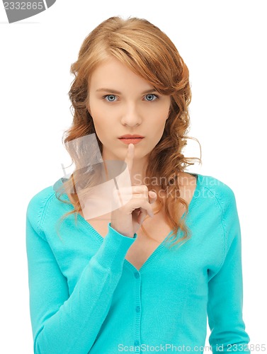 Image of teenage girl with finger on lips