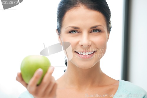 Image of lovely housewife with green apple