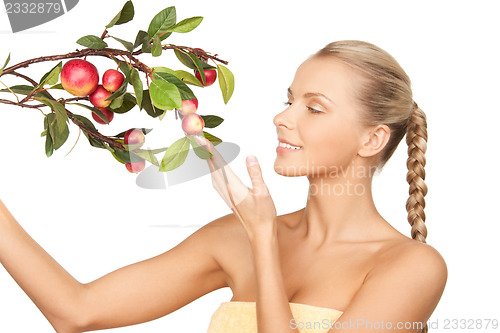 Image of lovely woman with apple twig