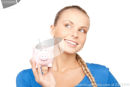 Image of lovely woman with piggy bank