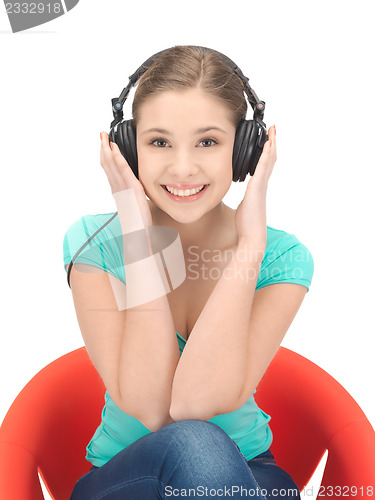 Image of happy teenage girl in big headphones