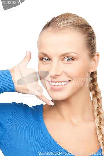 Image of woman making a call me gesture