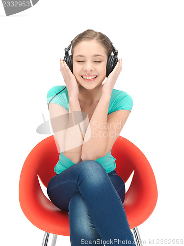 Image of happy teenage girl in big headphones