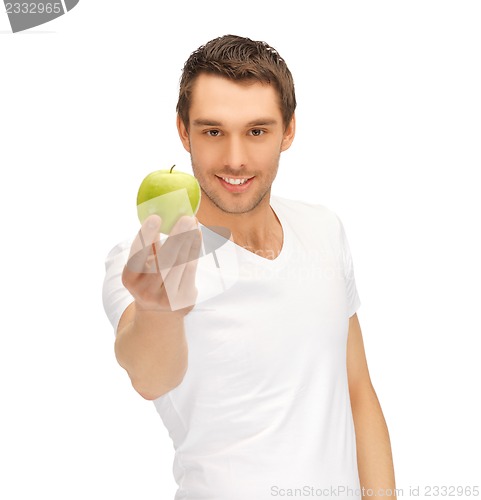 Image of man in white shirt with green apple