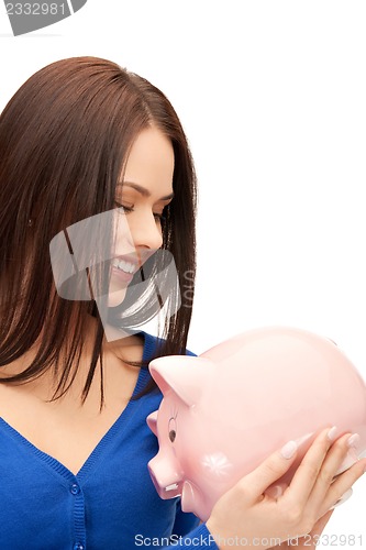 Image of lovely woman with piggy bank