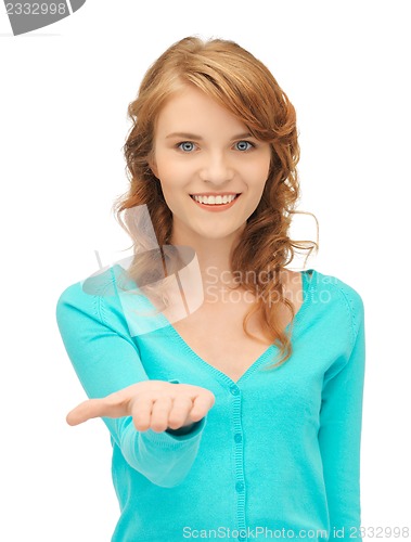 Image of girl showing something on the palm of her hand