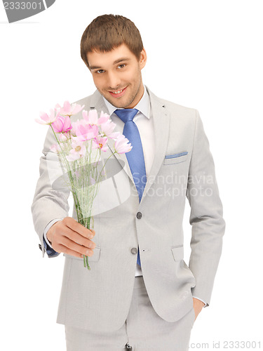 Image of handsome man with flowers in hand