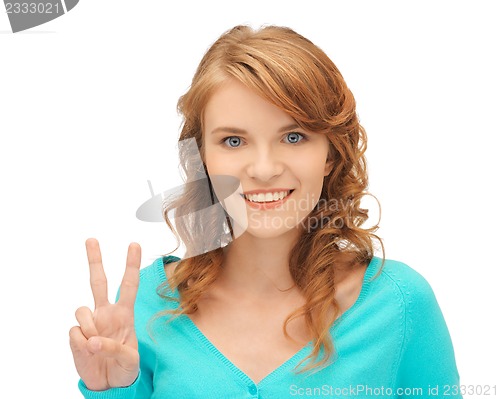 Image of teenage girl showing victory sign