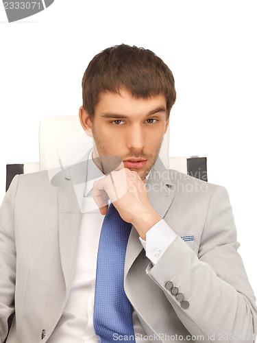 Image of young businessman sitting in chair