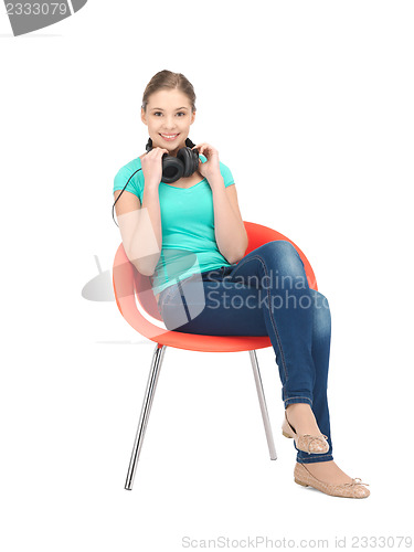 Image of happy teenage girl in big headphones