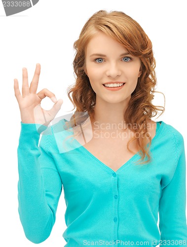 Image of teenage girl showing ok sign