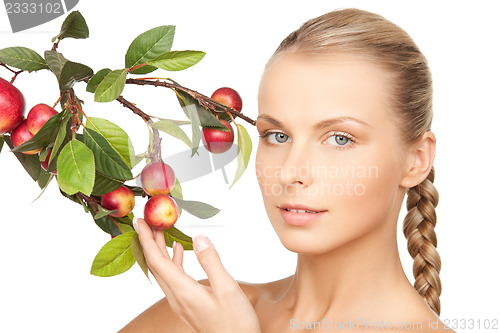 Image of lovely woman with apple twig