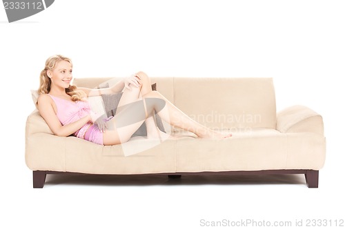 Image of happy woman on sofa