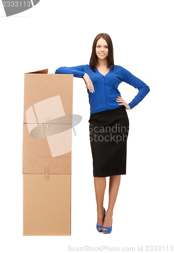 Image of attractive businesswoman with big boxes