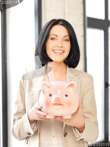 Image of lovely woman with piggy bank