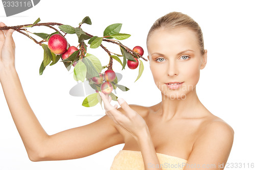 Image of lovely woman with apple twig