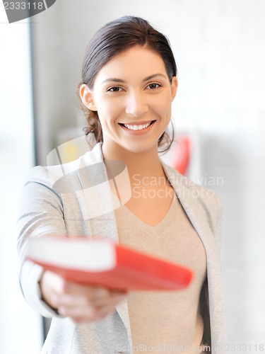 Image of happy and smiling woman with book