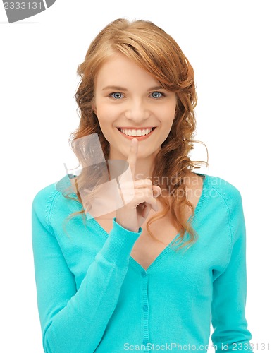 Image of teenage girl with finger on lips