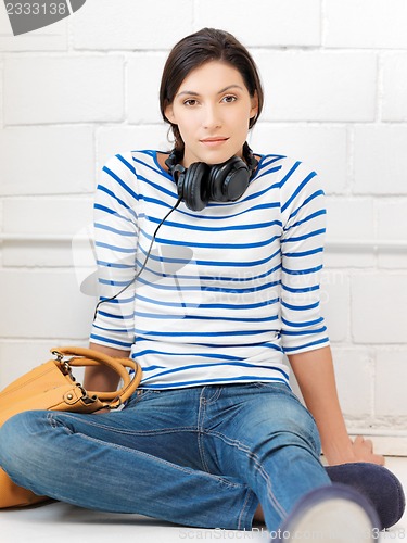 Image of happy teenage girl in big headphones