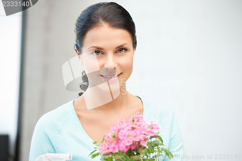 Image of lovely housewife with flower